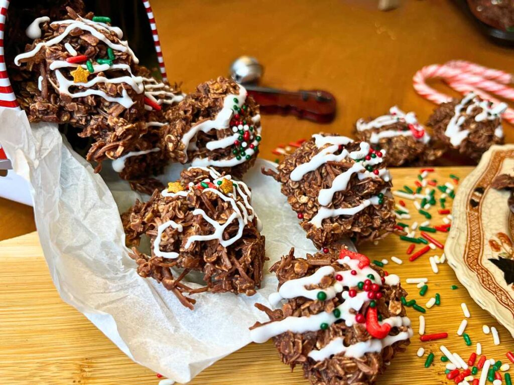 A close up look at decorated chocolate haystacks coming out of a Christmas cookie tin.