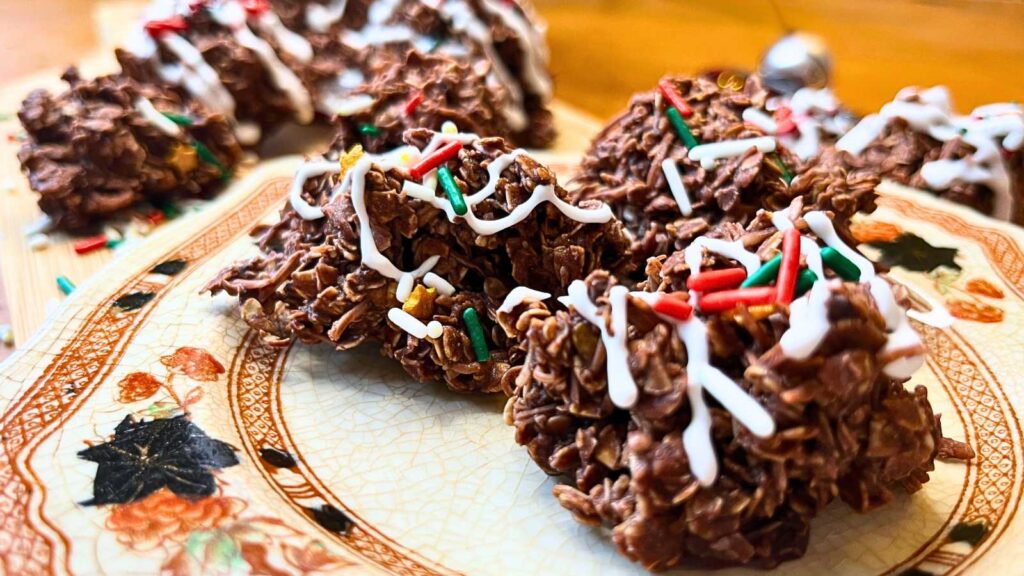 A close up view of some chocolate haystack cookies on a brown floral plate.