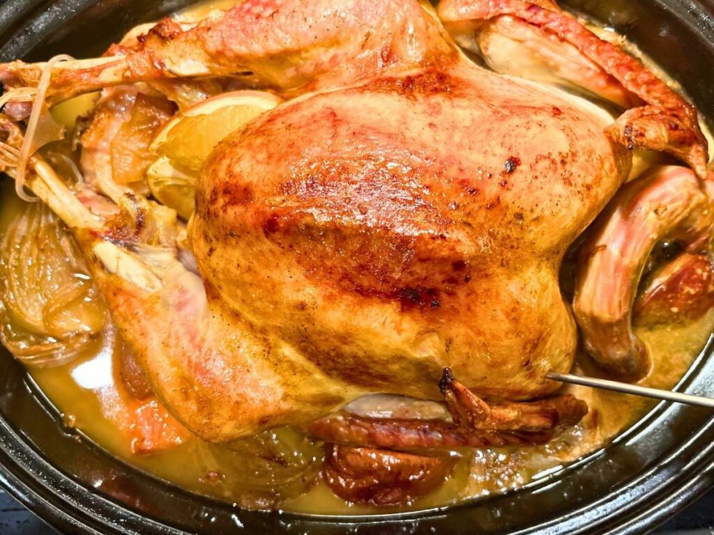 A roast maple turkey in a roasting pan.