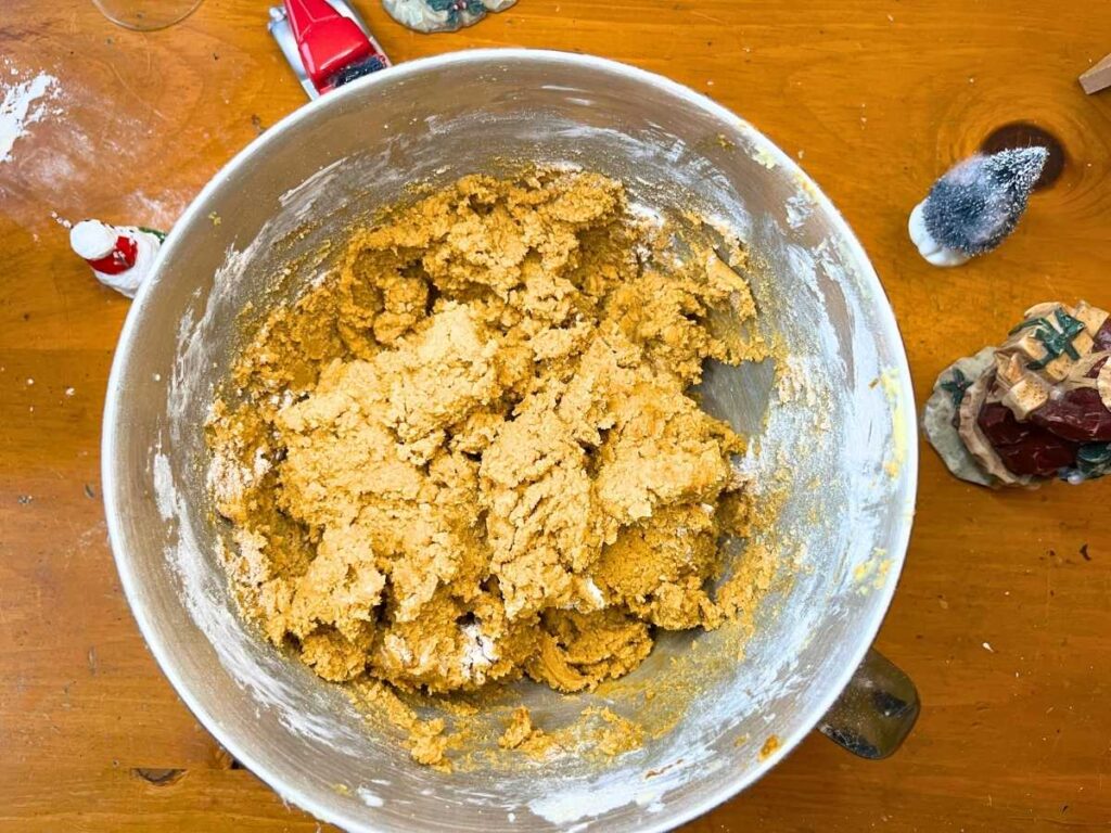 A metal bowl full of gingerbread dough.