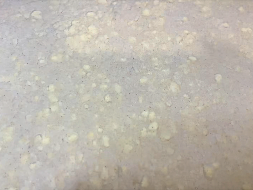 A close up view of all the pieces of laminated butter in the puff pastry dough.