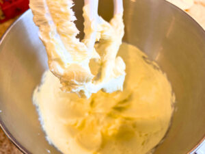 Creamed butter in the bowl of a stand mixer fitted with the paddle attachment.
