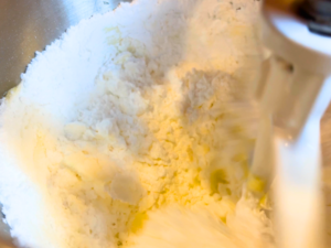 Butter and icing sugar in the bowl of a stand mixer fitted with a paddle attachment.