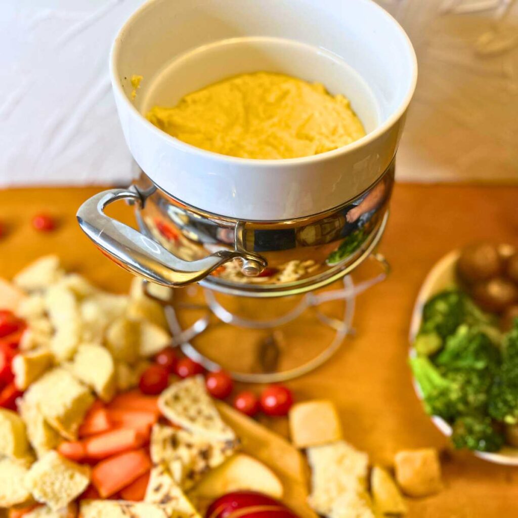 A cheese fondue surrounded by dippers.