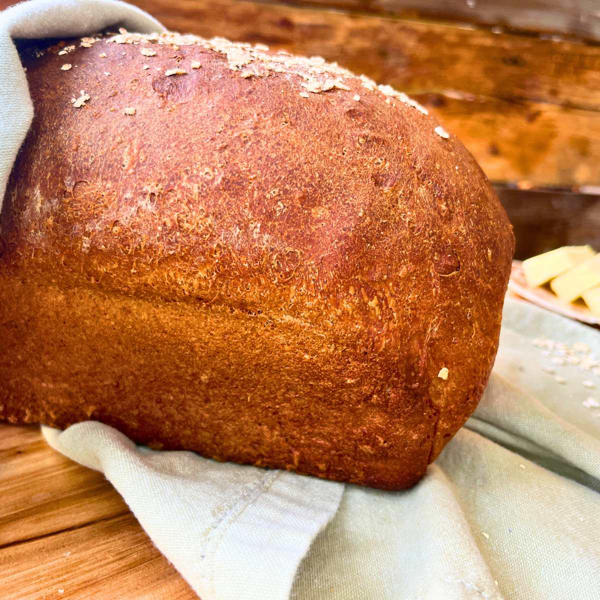 A side view of a loaf of brown bread.