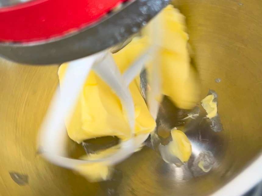 Butter in the bowl of a stand mixer with the paddle attachment.