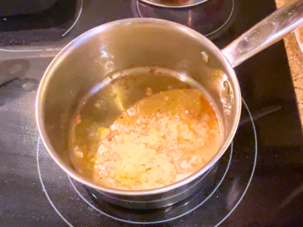 Ginger and garlic frying in a pot.
