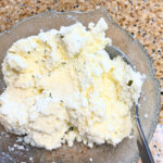 A glass bowl with ricotta cheese