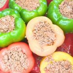 A casserole dish with bell peppers stuffed with ground meat.