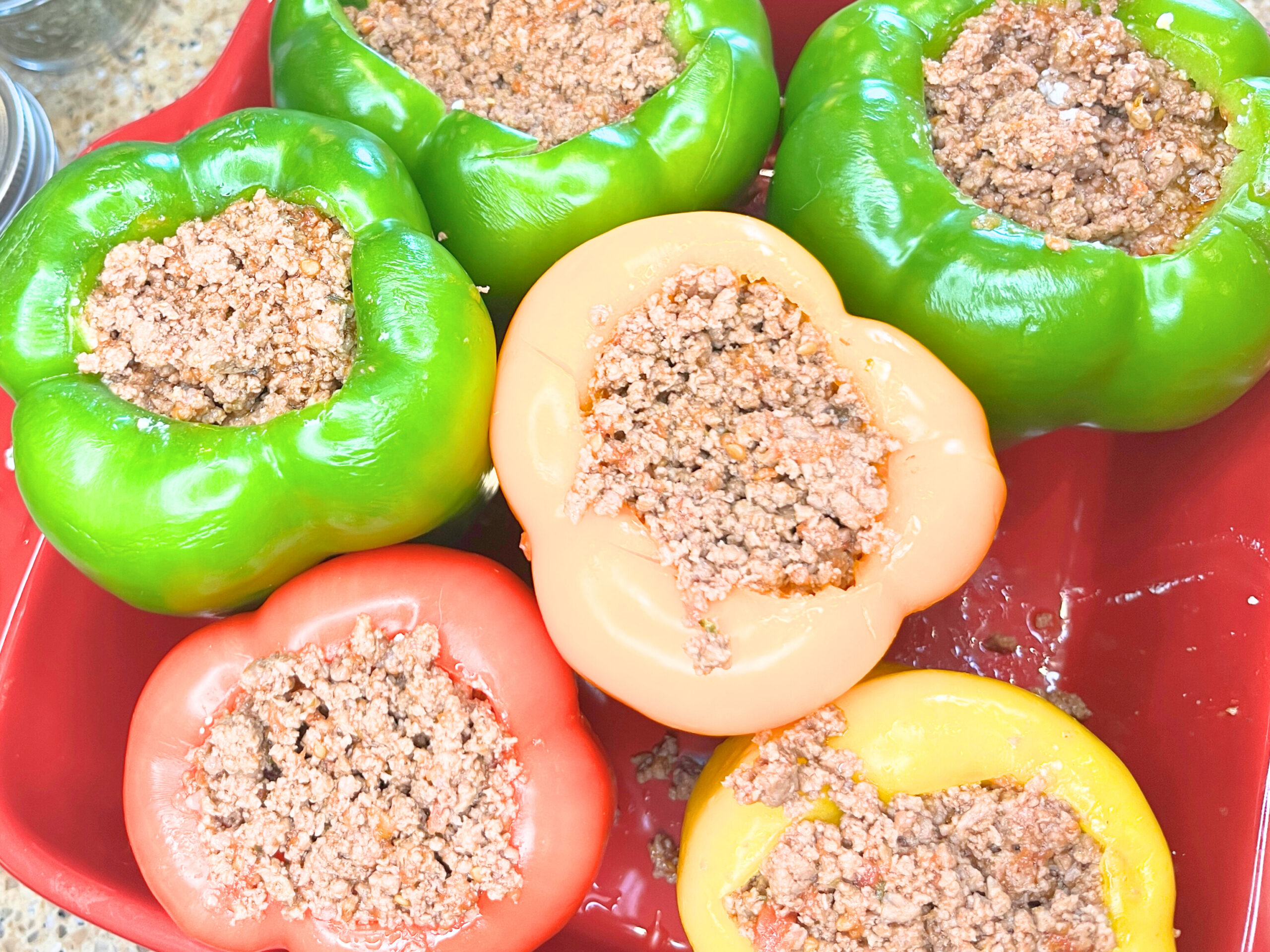 A casserole dish with bell peppers stuffed with ground meat.