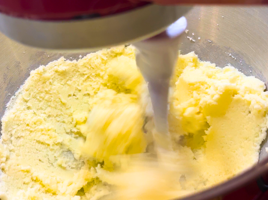 Butter and sugar creaming together in a stand mixer.
