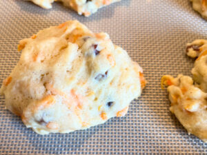 A close up look of a baked carrot cookie with raisins.