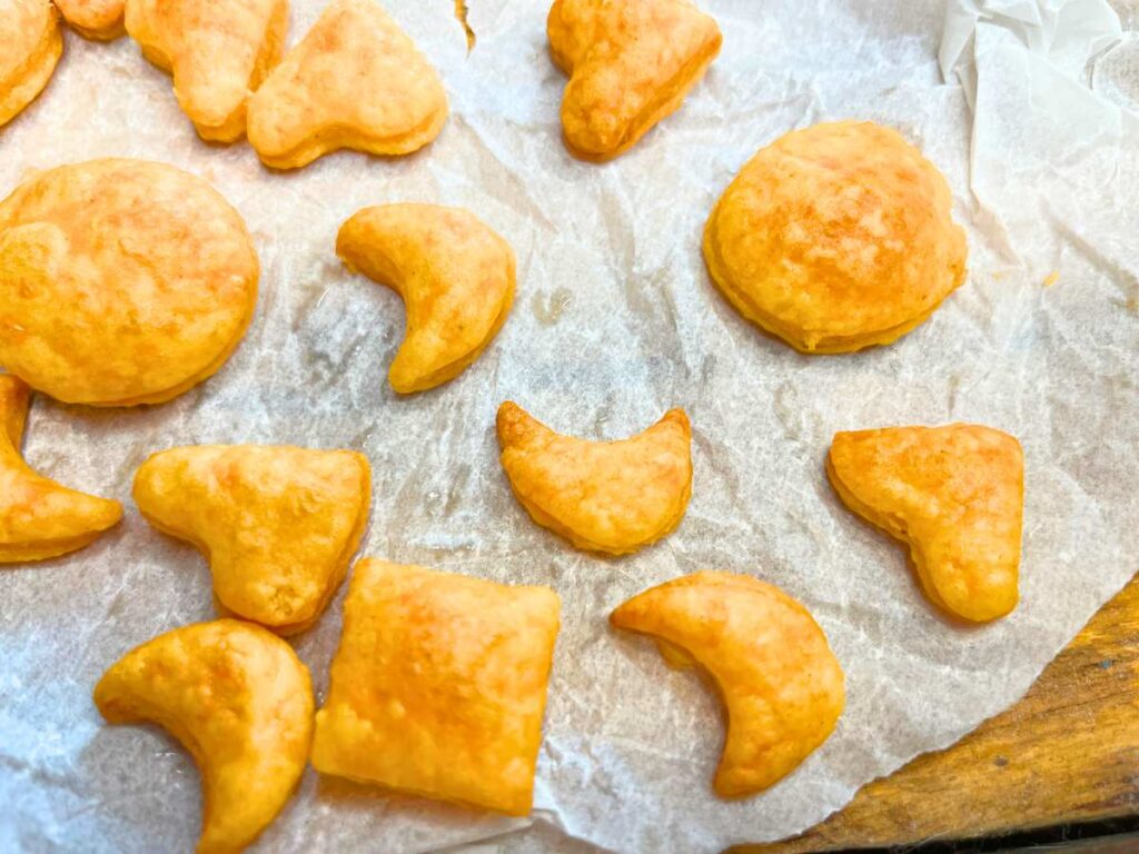 A few orange crackers in the shapes of circles, hearts, and moons.