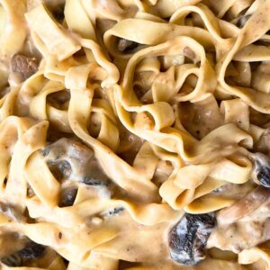 A close up look of a creamy pasta dish with beef and mushrooms.