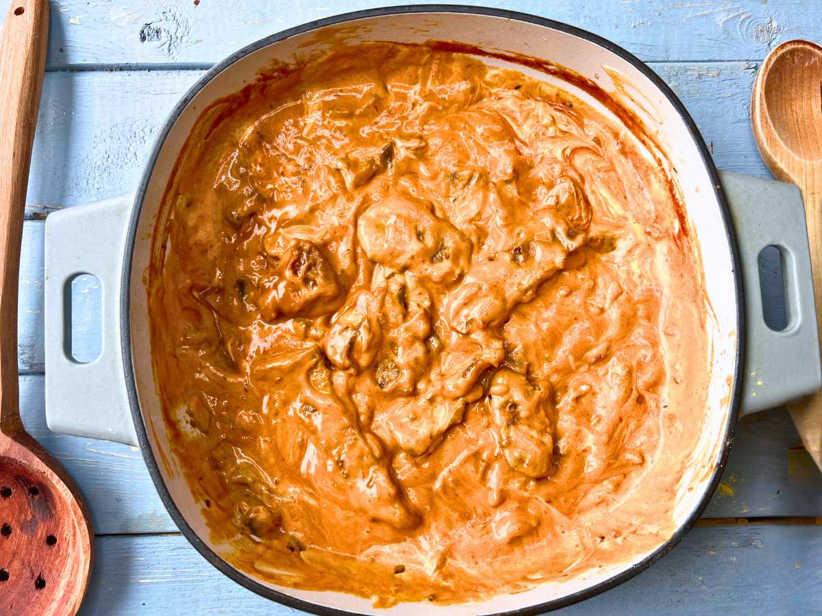 A Dutch oven with beef stroganoff inside.