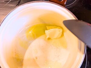 Melting butter in a white sauce pot.
