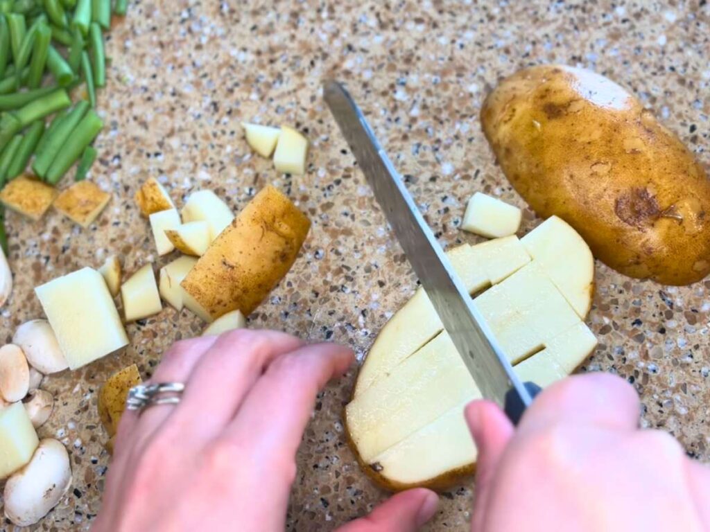 Woman cutting potatoes