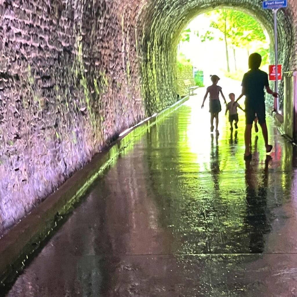 Children walking through a tunnel
