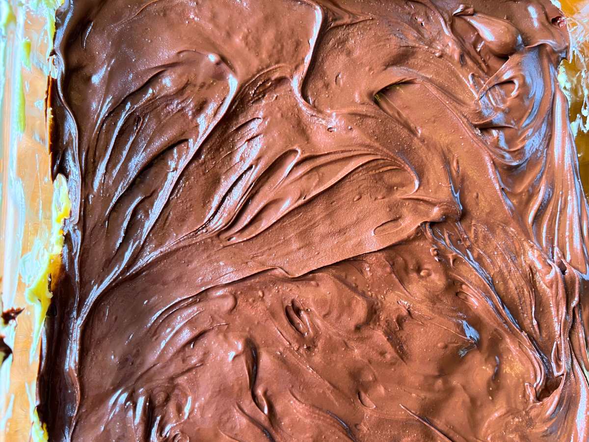 Chocolate spread on top of a dessert in a glass casserole dish.