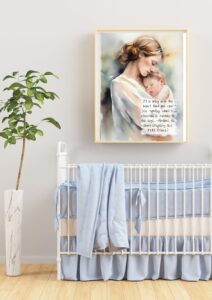 A nursery with a crib. There is a plant beside and a framed print with a vintage quote on the wall of a mother holding a baby.