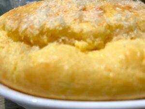 A close up view of the top of a cheese soufflé. 