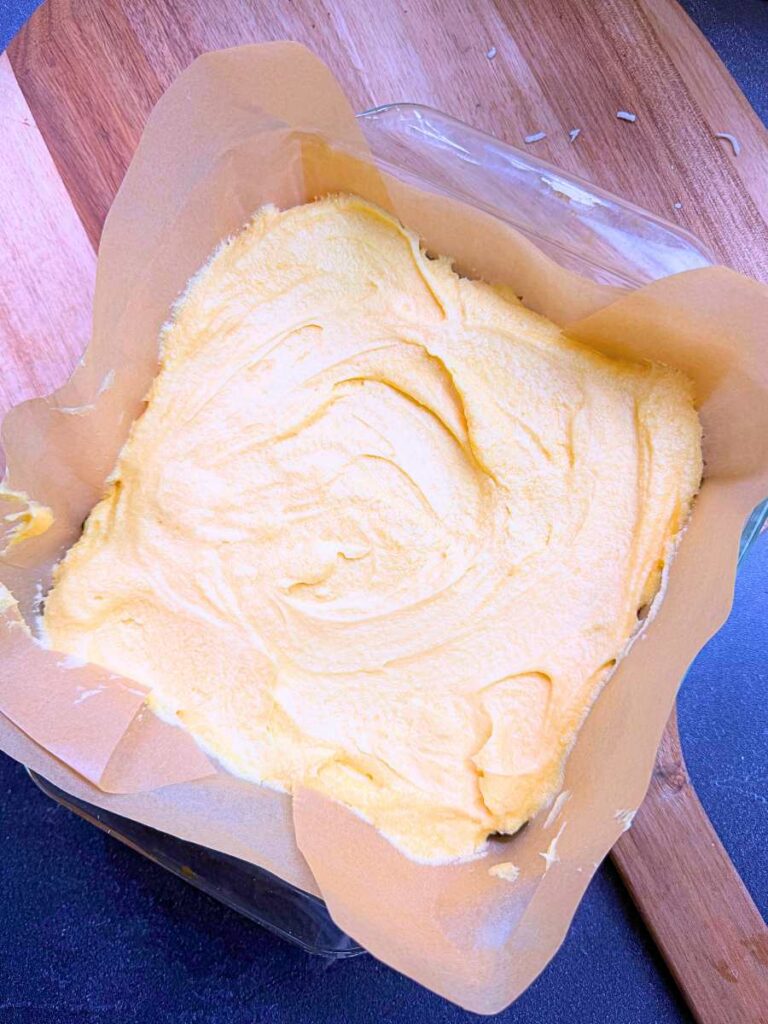 An overhead view of the custard layer of Nanaimo bars.