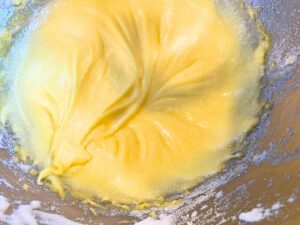 A metal bowl with creamed egg yolks, butter, and sugar.