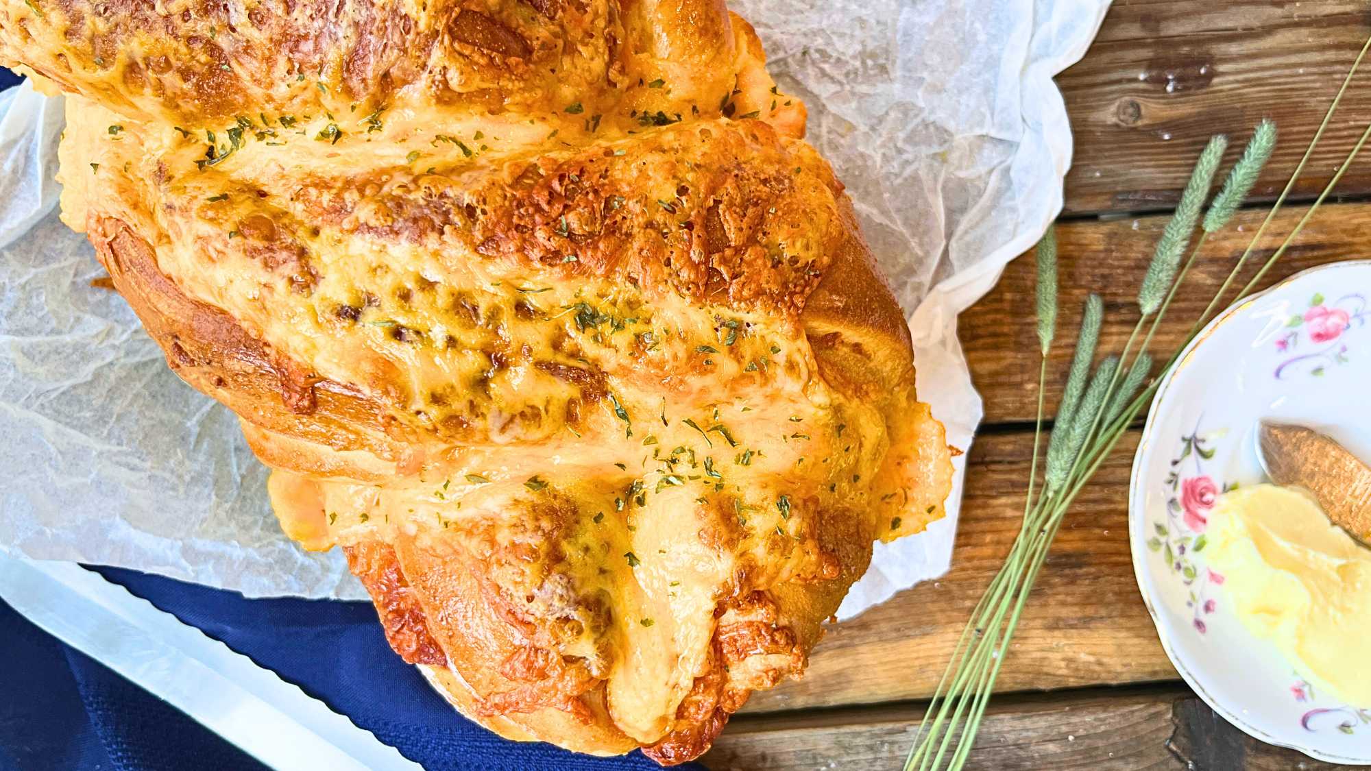 A cheese bread loaf on a wooden table.