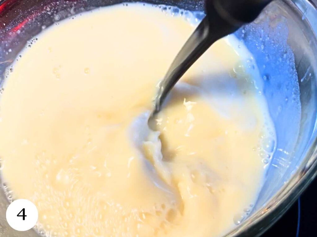 A glass bowl with a milk mixture inside.