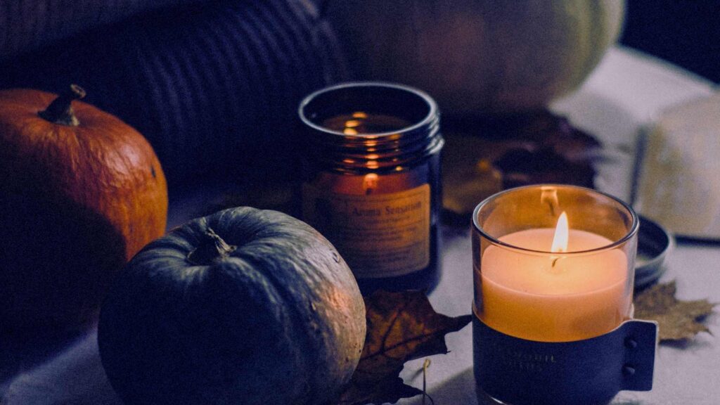 Candles and pumpkins in a dimly lit room