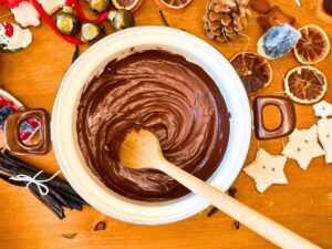 A large white pot with melted chocolate inside.