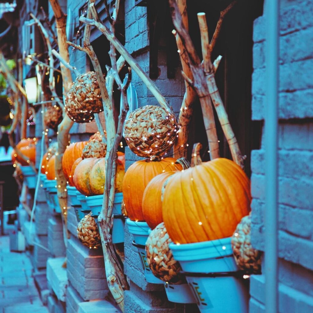 There are pumpkins decorating a streetscape.