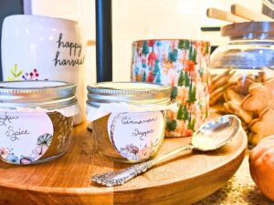 A two teared shelf with coffee mugs and spice jars.