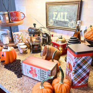 A fall coffee bar with coffee, tea, and hot chocolate supplies.