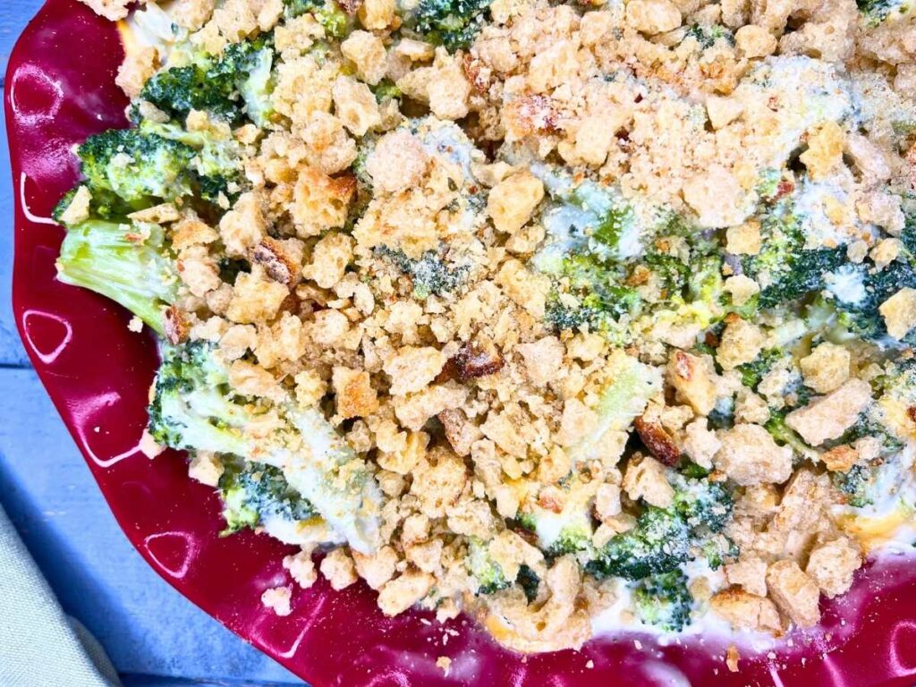 A close up view of a broccoli casserole with a bread crumb top.