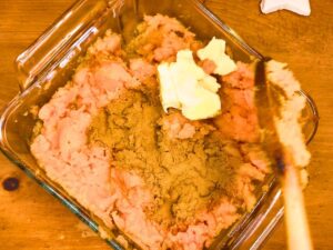 A casserole dish with mashed sweet potatoes, butter, cinnamon, and maple syrup.