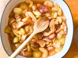 Cooked apples in a large grey pot.