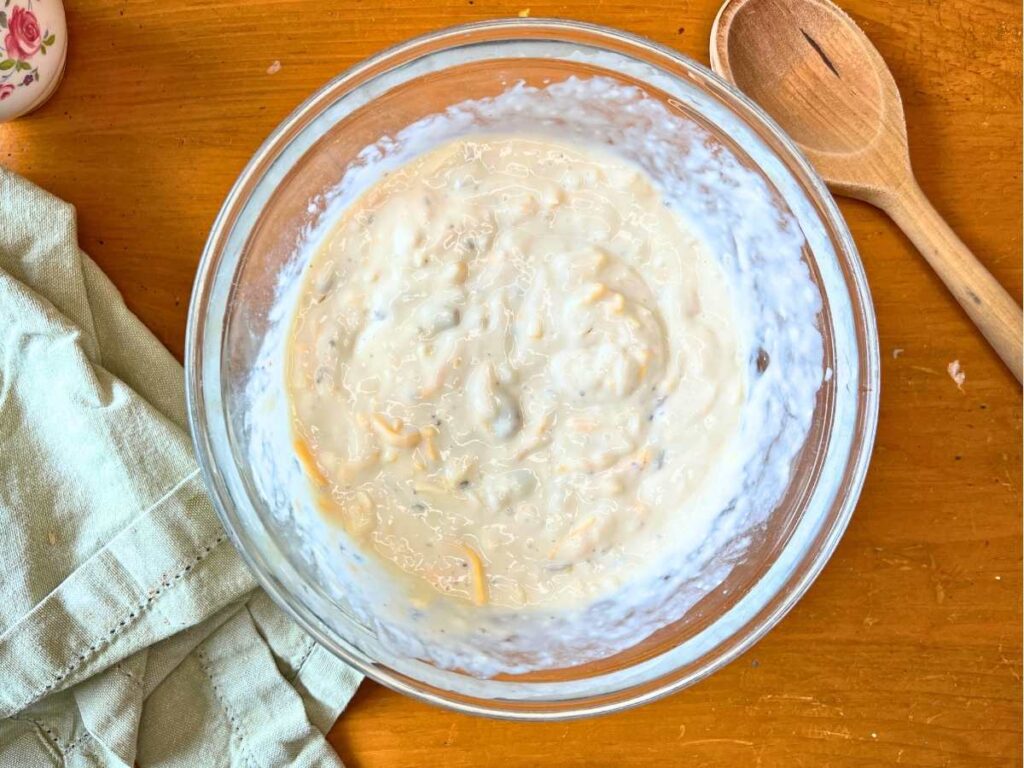 A glass bowl with a creamy mixture inside.