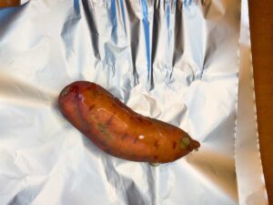 A sweet potato on a piece of foil.