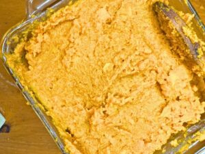 A sweet potato casserole smoothed out in a casserole dish.