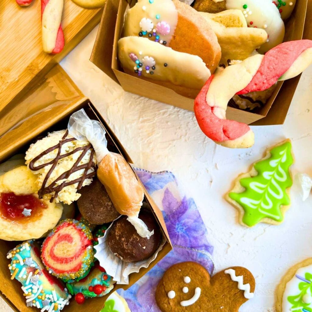 An arrangement of Christmas cookies in small brown treat boxes.