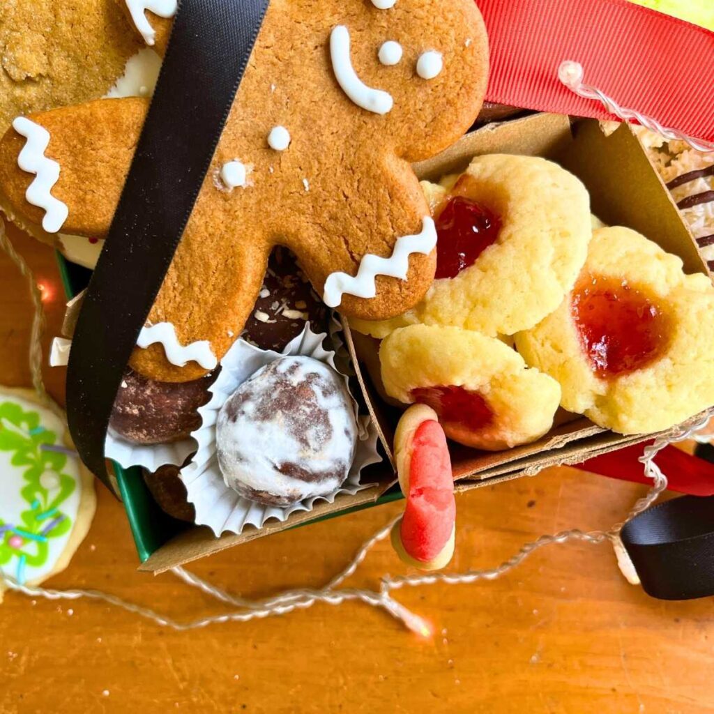 An overhead view of Christmas cookies arranged in a green box.