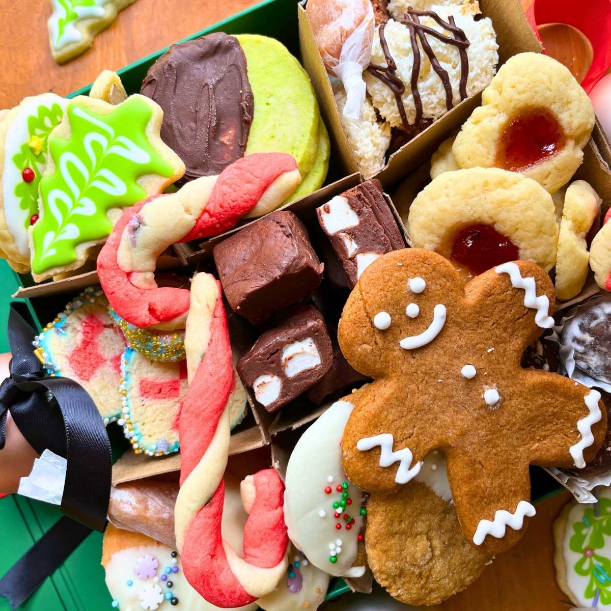 A collection of Christmas treats in a green box.