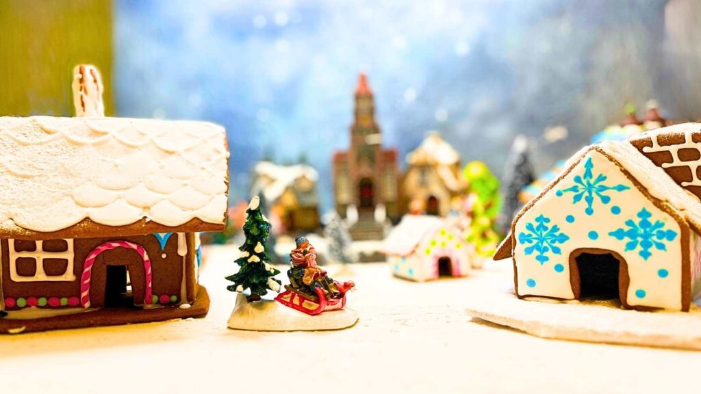 Some gingerbread houses decorated and set up in a Christmas villange