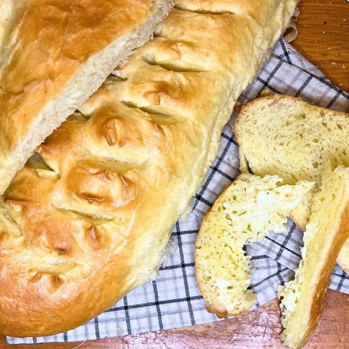 Two loaves of bread. One is sliced.