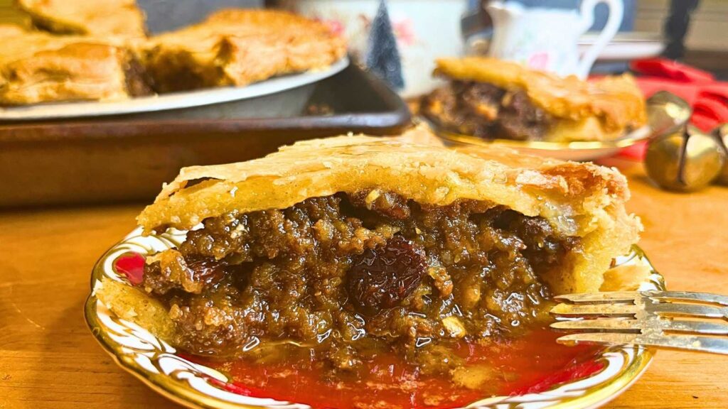 A slice of pie showing the inside of the meat filling.