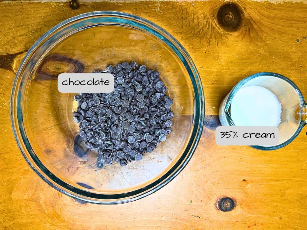 chocolate chips and cream on a wooden table. They are labeled.