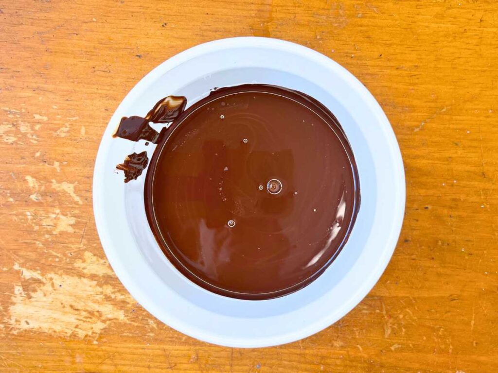 Melted chocolate in a white bowl.