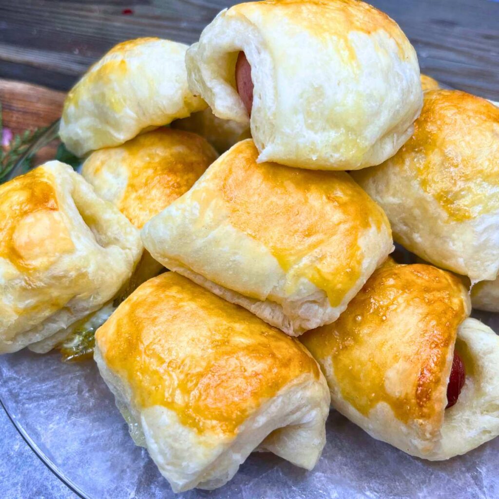 A stack of puff pastry appetizers stuffed with hotdogs.