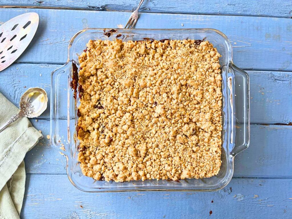 Baked date squares in a glass casserole dish.